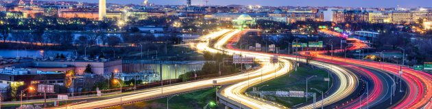 Washington D.C., skyline with highways and monuments.