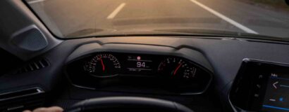 hands of car driver on steering wheel, road trip, driving on highway road