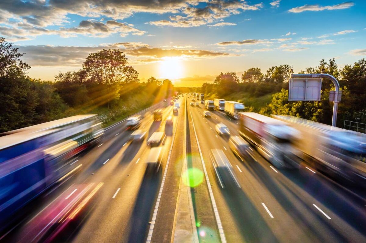 Heavy traffic on the motorway at sunset with speed effect and luminous flow