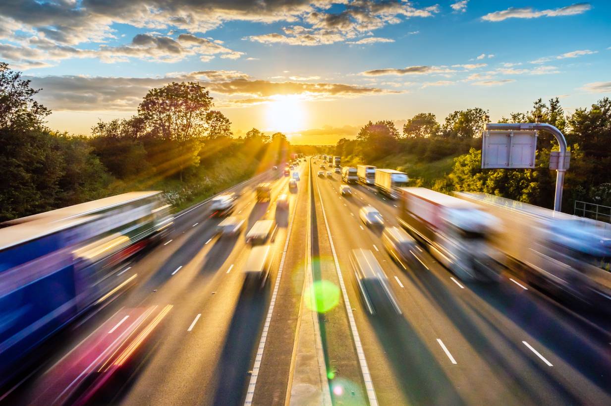 Heavy traffic on the motorway at sunset with speed effect and luminous flow
