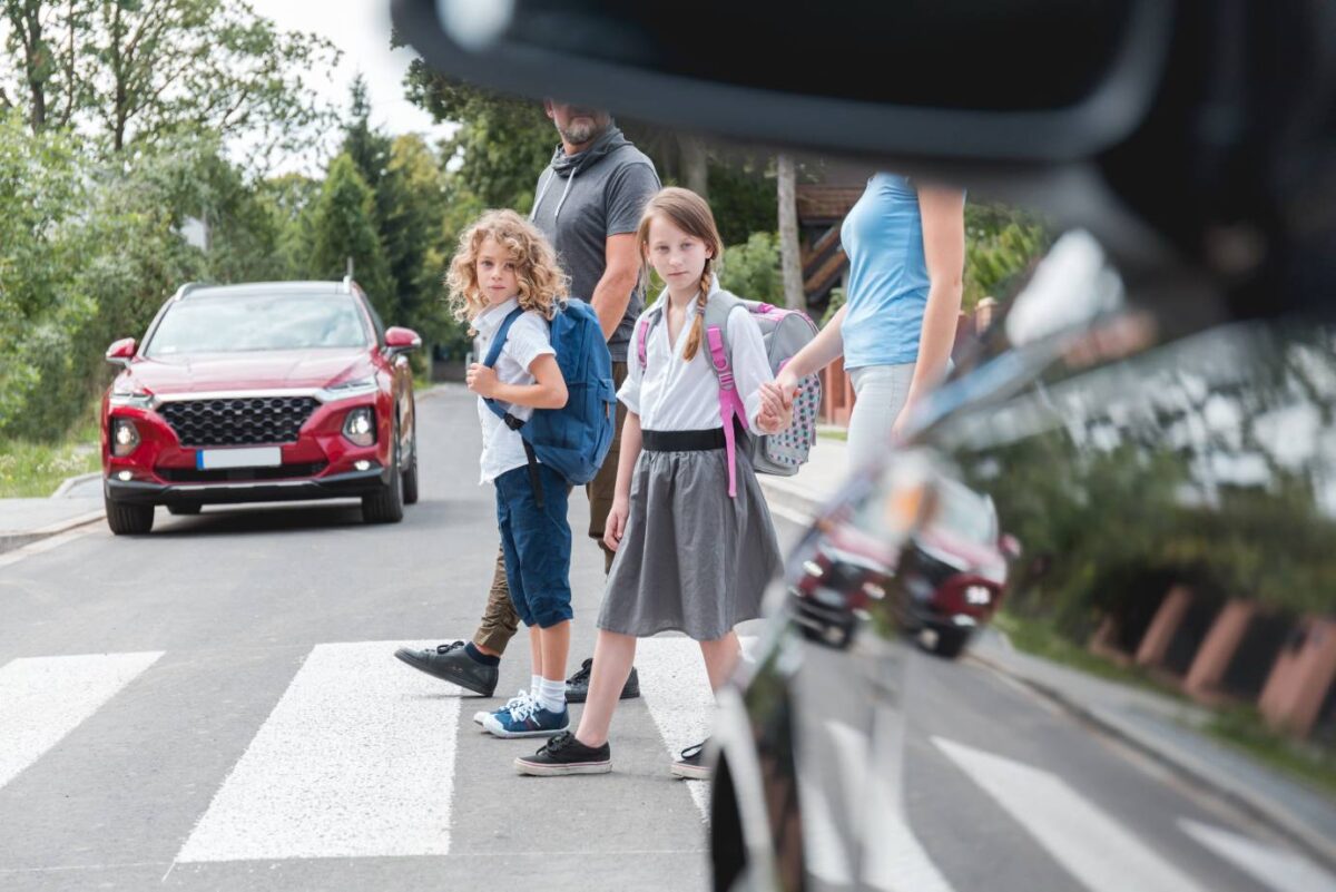 schoolchildren crossing a pedestrian crossing